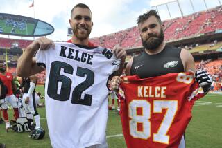 Kansas City Chiefs Travis Kelce, left, and Philadelphia Eagles Jason Kelce exchange jerseys