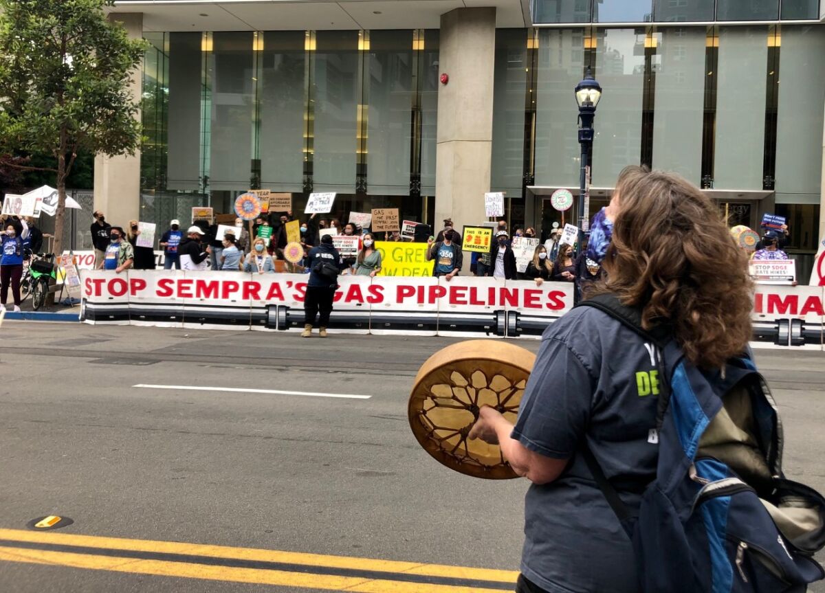About 100 environmentalists protest in front of the corporate headquarters of Sempra Energy.
