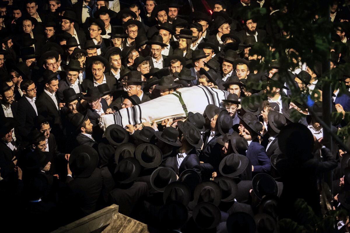 Ultra-Orthodox Jews with festival stampede victim