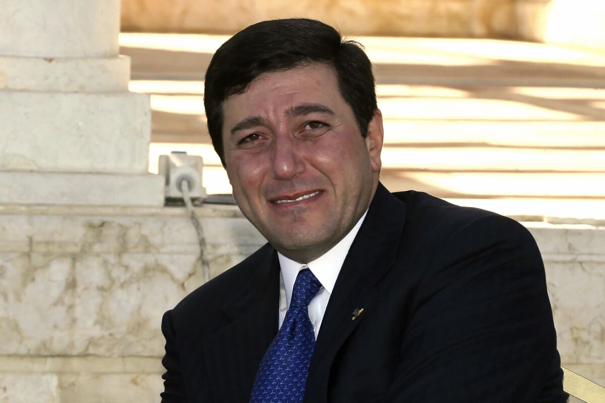 Closeup of a smiling Bassem Awadallah in a suit and tie.