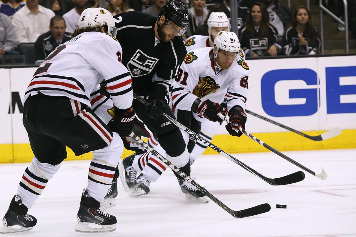 Kings forward Marian Gaborik battles Chicago defensemen Duncan Keith and Marian Hossa during Game 6 of the Western Conference finals on Friday.