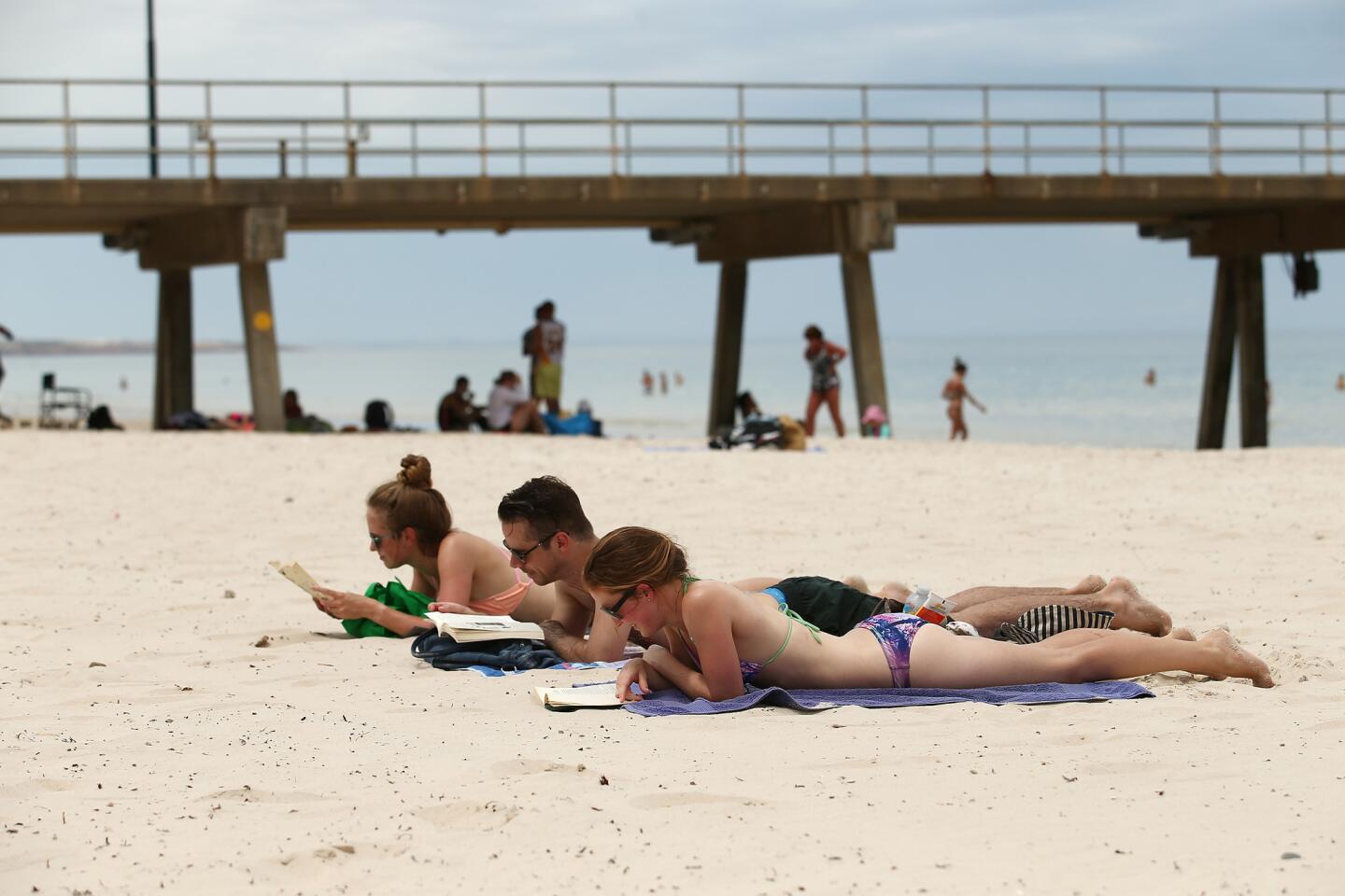 Beachgoers relax on Glenelg Beach on Dec. 19, 2015 in Adelaide, Australia, during a heat wave when temperatures topped 40 degrees Celsius (104 degrees Fahrenheit). It's summer Down Under and Adelaide is popular for its wineries, public gardens and architecture.