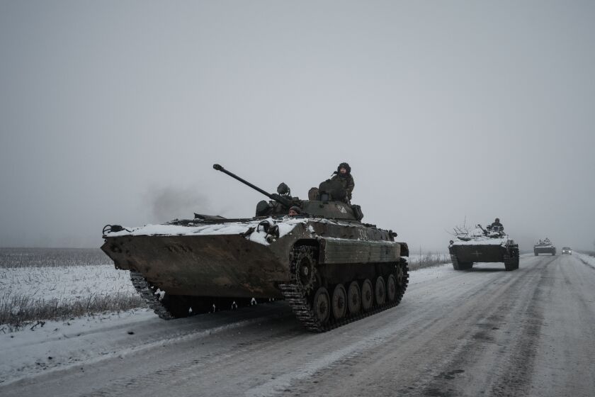 TOPSHOT - Ukrainian BMP-2 infantry combat vehicles drive in a convoy down an icy road in the Donetsk region on January 30, 2023, amid the Russian invasion of Ukraine. (Photo by YASUYOSHI CHIBA / AFP) (Photo by YASUYOSHI CHIBA/AFP via Getty Images)