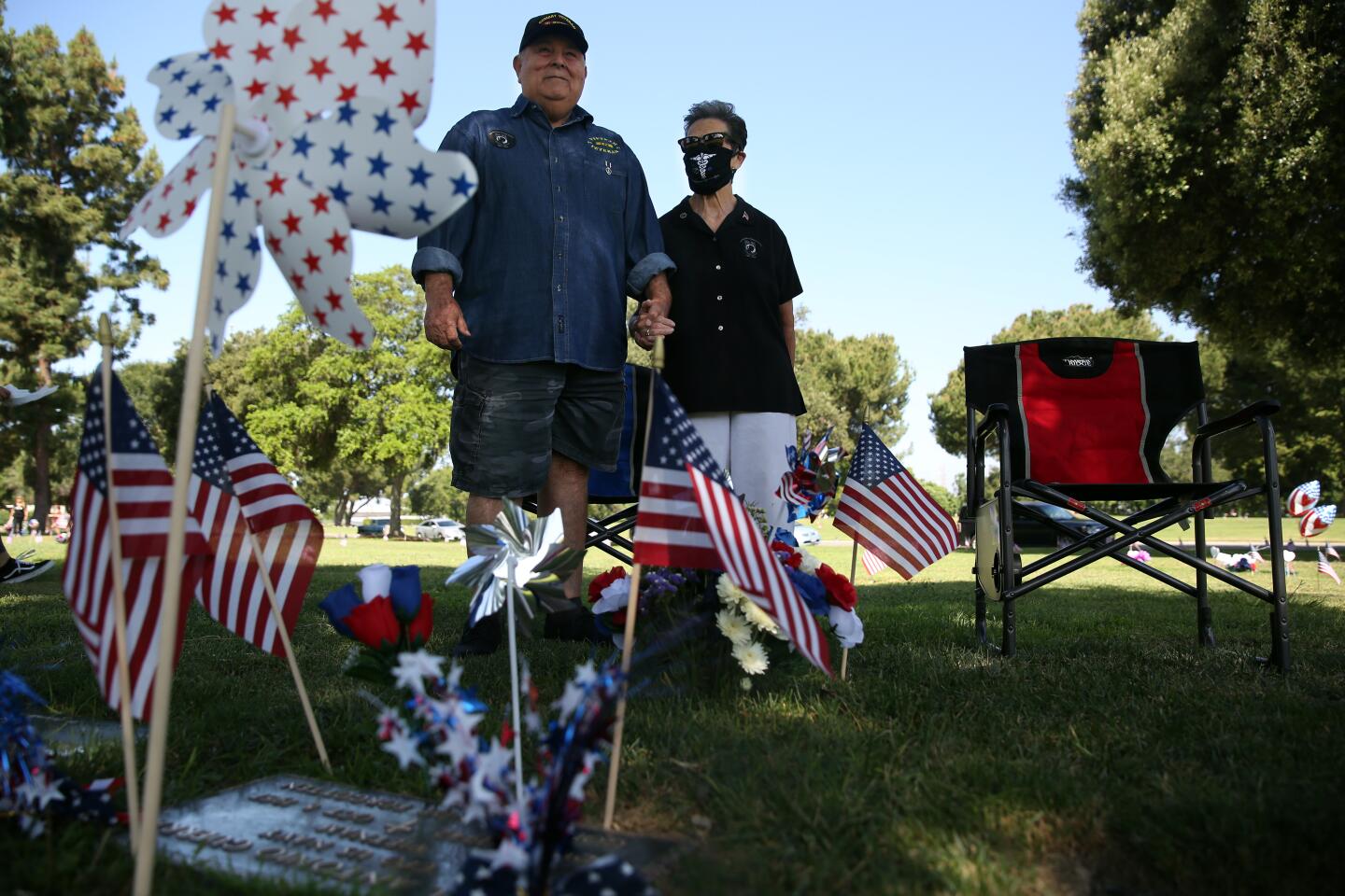 Ruben and Emily Valencia visit the gravesite of Raul Guerra at Rose Hills Memorial Park on Monday in Whittier.
