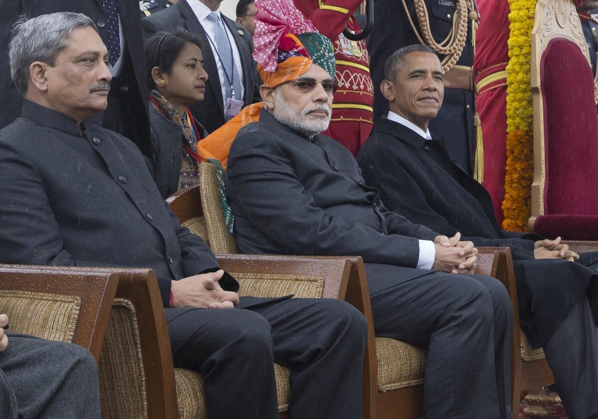 President Obama sits with Indian Prime Minister Narendra Modi, center, during the Republic Day parade in New Delhi on Jan. 26.