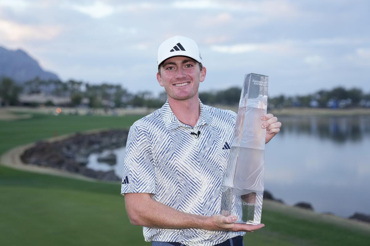 Nick Dunlap celebrates after winning The American Express golf tournament at La Quinta Country Club on Sunday.