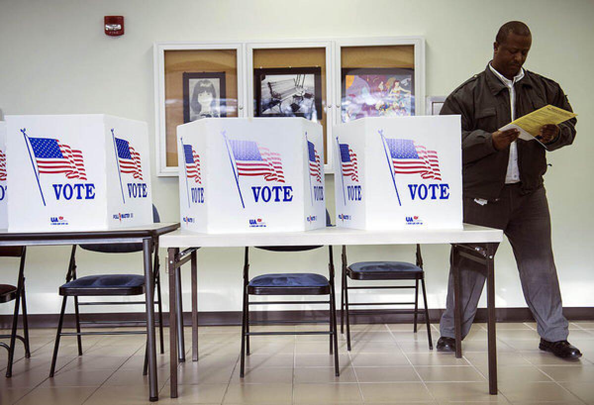 A voter in Lancaster, Ohio, gets up after filling out a paper ballot during the final day of early voting in the state.