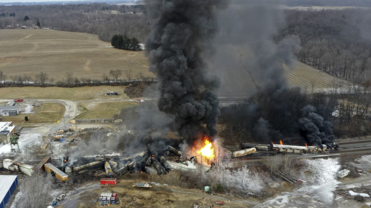 FILE - This photo taken with a drone shows portions of a Norfolk and Southern freight train that derailed Friday night in East Palestine, Ohio are still on fire at mid-day Saturday, Feb. 4, 2023. Soon after the train derailed and spilled toxic chemicals in Ohio last month, anonymous pro-Russian accounts started spreading misleading claims and anti-American propaganda about it on Twitter, using Elon Musk's new verification system to expand their reach while creating the illusion of credibility. (AP Photo/Gene J. Puskar, File)