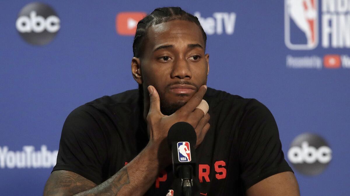 Toronto Raptors forward Kawhi Leonard speaks to reporters before a practice session on June 12. When will Leonard make his free agency decision?