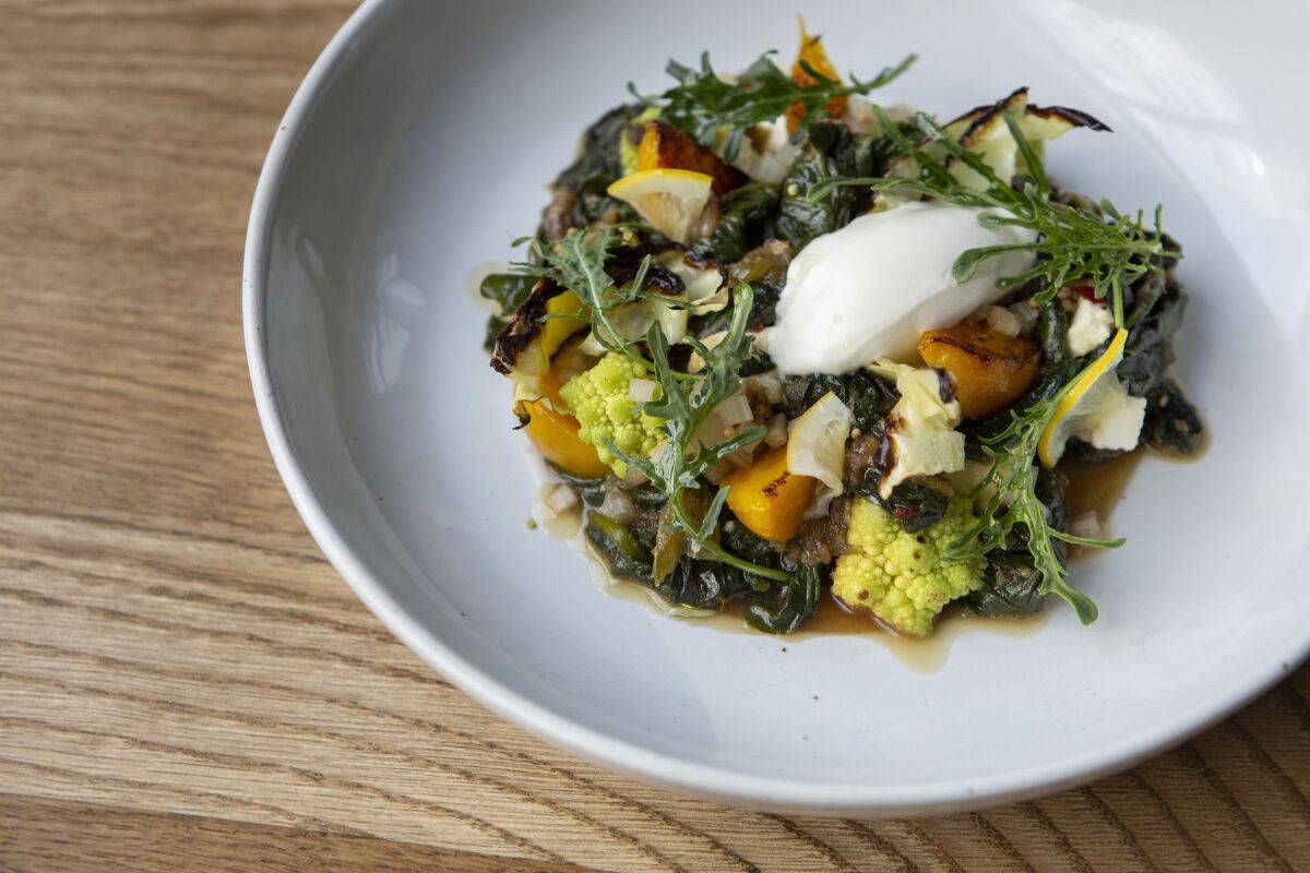 The chard saag entree includes house-made feta, romanesco cauliflower and winter brassicas.