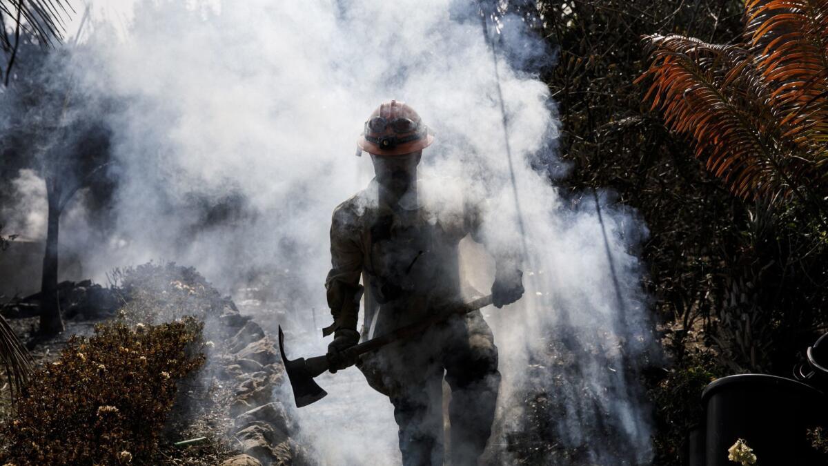 L.A. County firefighter Capt. Victor Correa works on the Woolsey fire in Malibu.