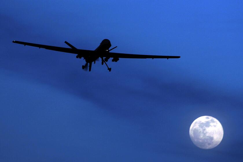 FILE - In this Jan. 31, 2010, file photo, an unmanned U.S. Predator drone flies over Kandahar Air Field, southern Afghanistan, on a moon-lit night. The White House has a released a version of President Barack Obama’s three-year-old directive on the use of lethal force against terrorists overseas, laying out what it says are safeguards to minimize civilian deaths and errant strikes while preserving the capability to take quick action with drone attacks and other means.(AP Photo/Kirsty Wigglesworth, File)