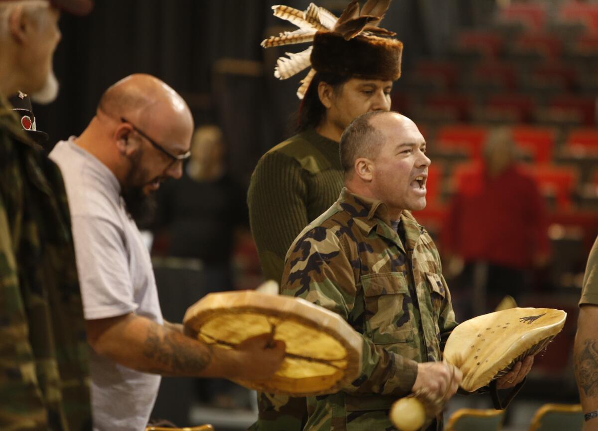 Native American veterans sing before a cleansing ceremony held by tribal members at the Prairie Knights Casino.