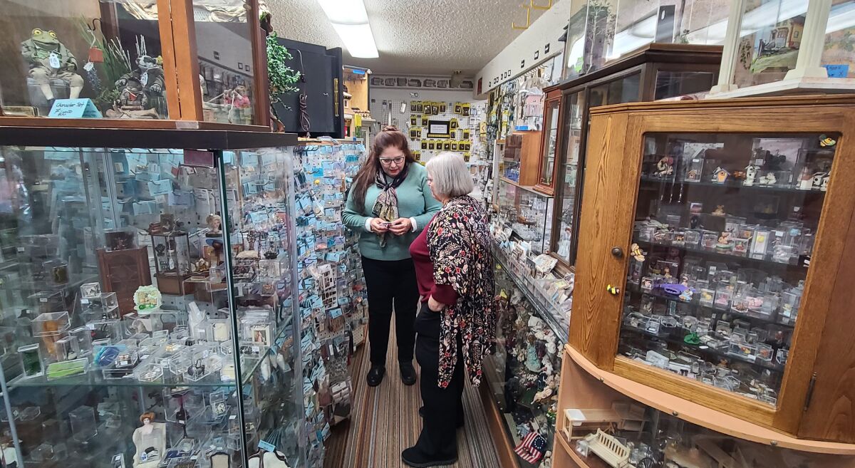 Michael Sue Nanos, right, helps a customer in her store, Ms. Peggie’s Place.