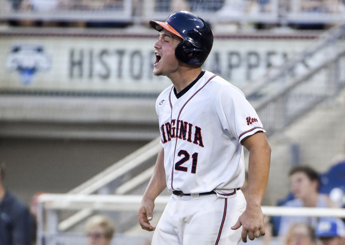 Virginia catcher Matt Thaiss celebrates after scoring on a two-run double by infielder Kenny Towns during the fifth inning of a College World Series game Saturday against Florida.