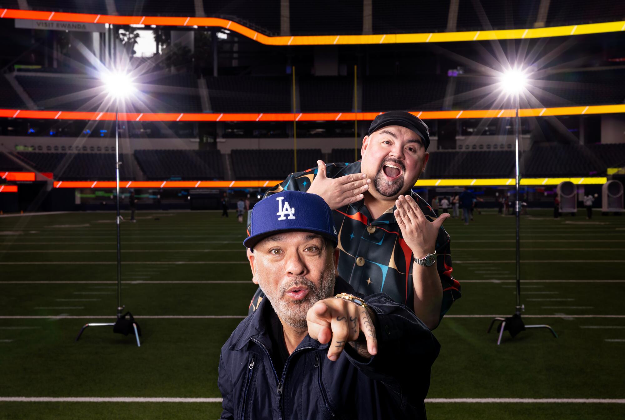 Comedians Jo Koy, in front, and Gabriel Iglesias on the field at SoFi Stadium in ahead of their sold-out March 21st show.