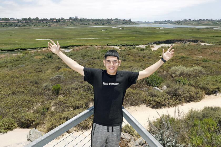 Back Bay High senior Nathan Bautista, 18, poses at the Peter and Mary Muth Interpretive Center at Upper Newport Bay Nature Preserve, a quiet space where he would study or go just to clear his mind from all the distractions in his life. Bautista is headed to Rio Hondo College in El Monte to study architecture in the Fall.