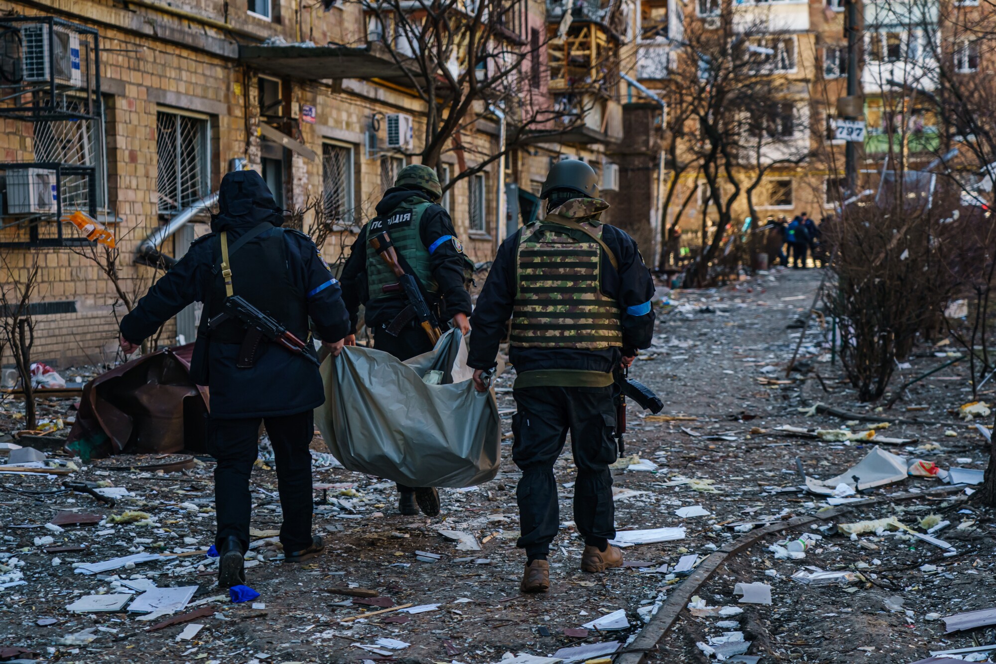 Police officers carry a dead body away after a residential area was struck by a Russian missile strike in Kyiv, Ukraine.