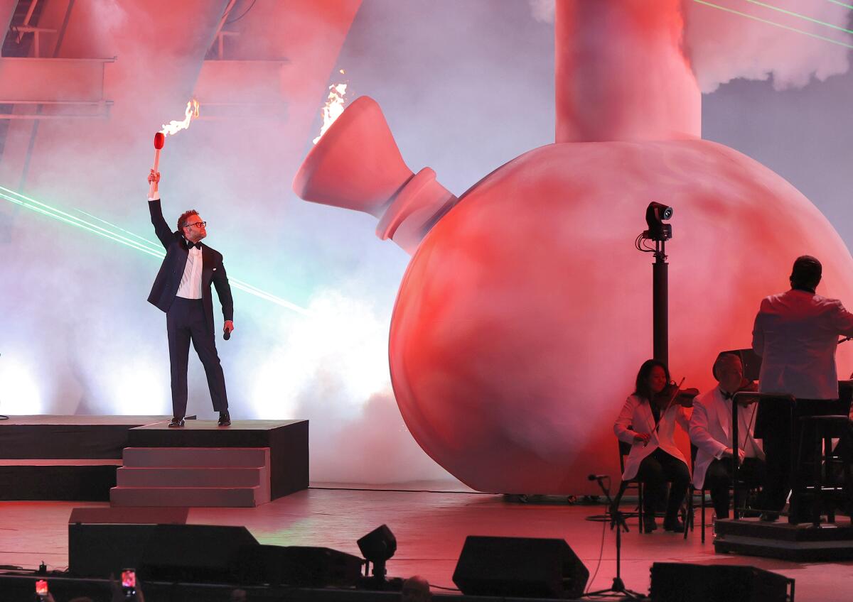 Man lighting a giant bong on stage