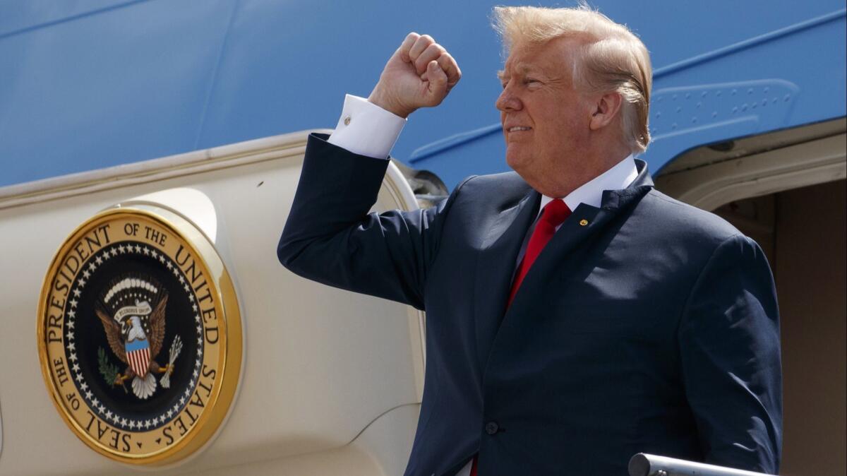 President Trump pumps his fist as he steps off Air Force One after arriving at Ellington Field Joint Reserve Base in Houston on May 31, 2018.