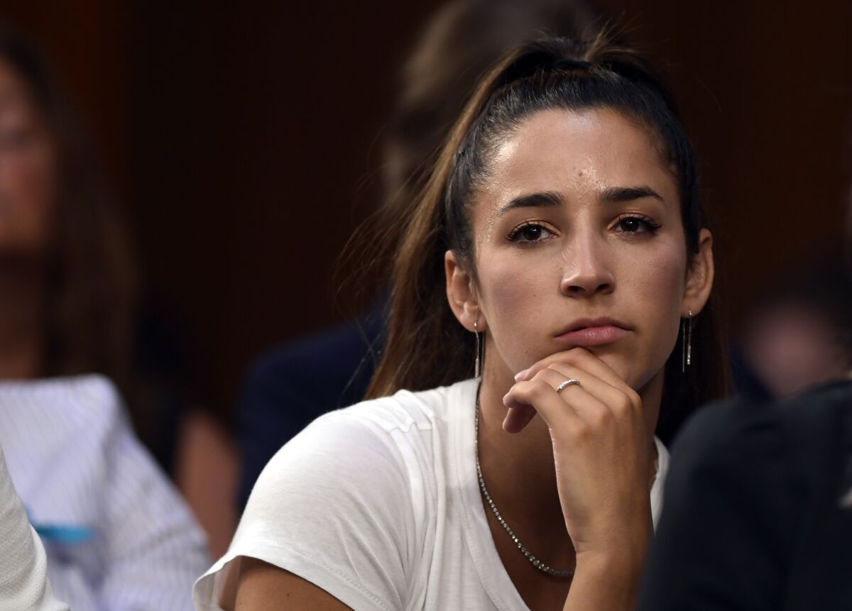 FILE - In this July 24, 2018 file photo, Olympic gold medalist Aly Raisman listens to testimony during a Senate Commerce subcommittee hearing in Washington. Raisman is looking for her beloved dog, who ran away scared during a weekend fireworks show in Boston. "My dog Mylo was terrified of fireworks and ran off," she tweeted Saturday, July 3, 2021, "He has a tag on and a leash. Please let me know if you see him." (AP Photo/Susan Walsh, File)