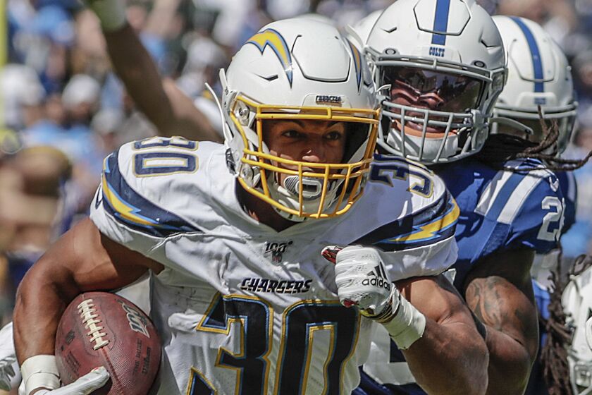 CARSON, CA, SUNDAY, SEPTEMBER 8, 2019 - Chargers running back Austin Ekeler races past Colts defenders for a 55-yard touchdown catch and run in the third quarter at Dignity Health Sports Park. (Robert Gauthier/Los Angeles Times)