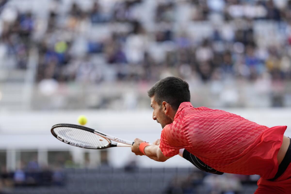 Djokovic - half volley, Novak Djokovic stretching to hit a …