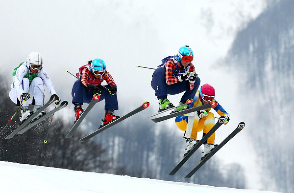 Canada's Mariell Thompson leads the finalists over a jump during the women's ski cross on Friday at Rosa Khutor Extreme Park.