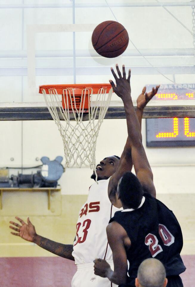 GCC's Mike Johnson drives inside for a shot attempt against Compton's Luis Engleton in the second half in a non-conference men's basketball game at GCC on Friday, November 9, 2012.