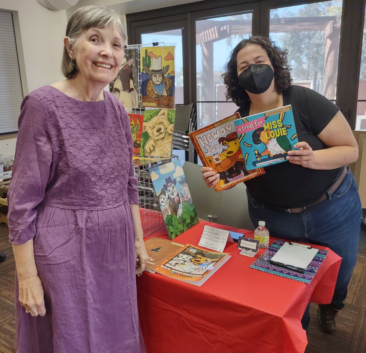 Friends of the Ramona Library President Maxine McNamara, left, talks with Ramona author Charlene Pulsonetti.