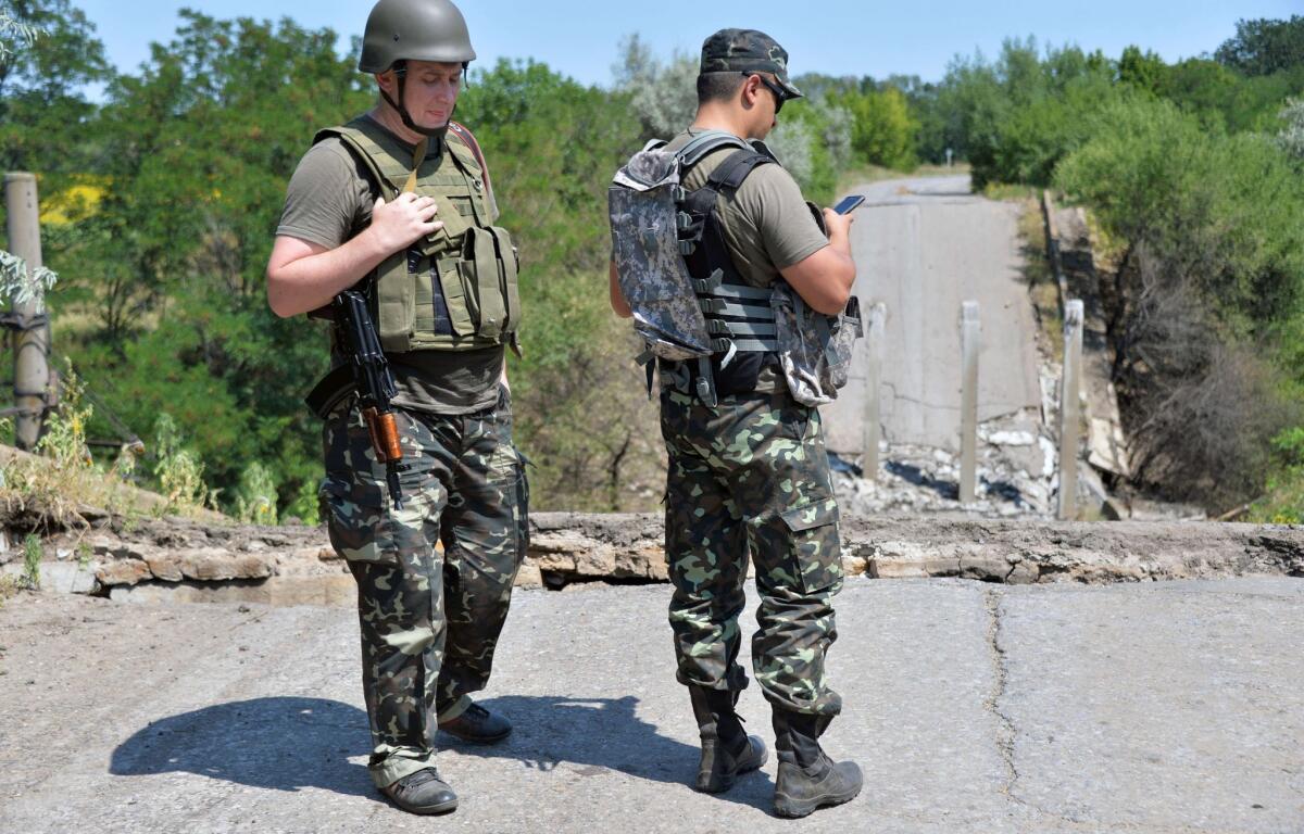 Ukrainian service at a bridge destroyed by pro-Russia militants in the village of Zolotarevka, near the eastern Ukrainian city of Lysychansk, in the region of Lugansk, on July 25, 2014.