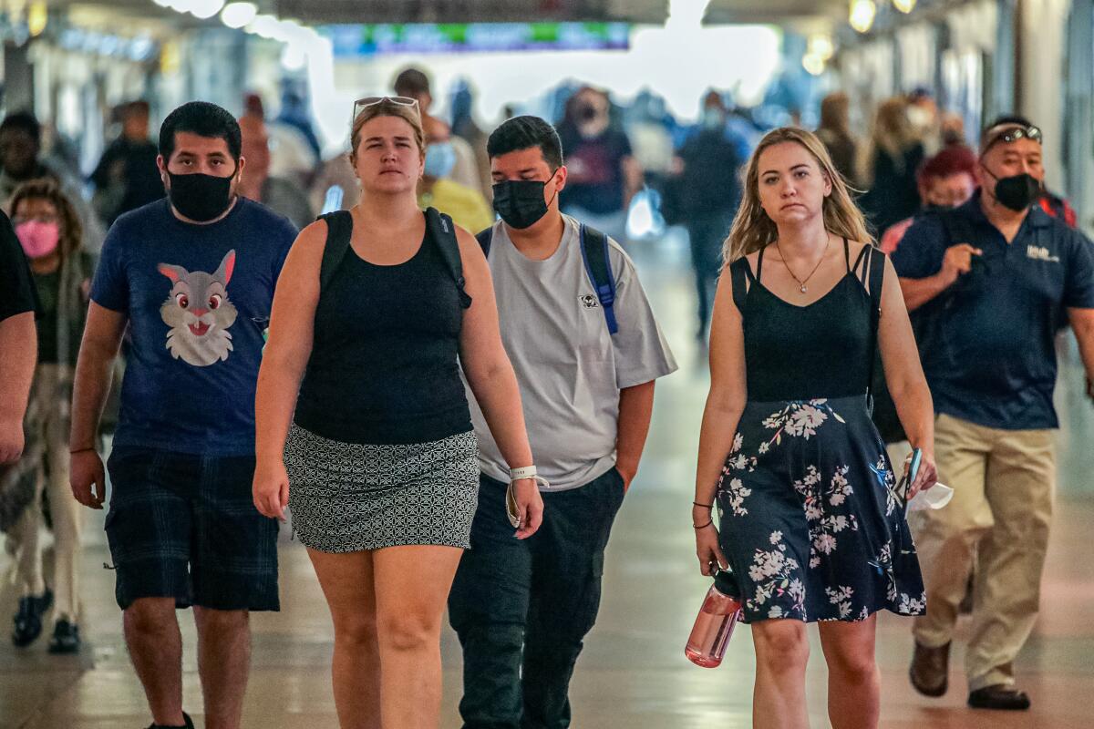 Commuters walk through Union Station in Los Angeles.