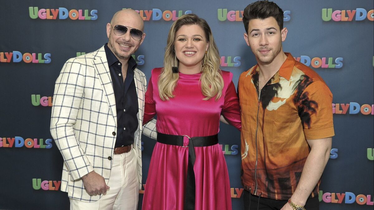 Pitbull, left, Kelly Clarkson and Nick Jonas are all voices in "UglyDolls."