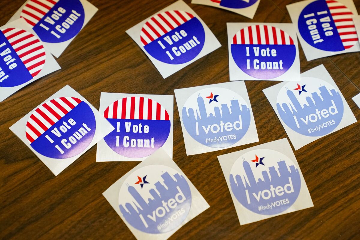 Stickers await voters during primary election voting in Indianapolis, Tuesday, May 3, 2022. (AP Photo/Michael Conroy)
