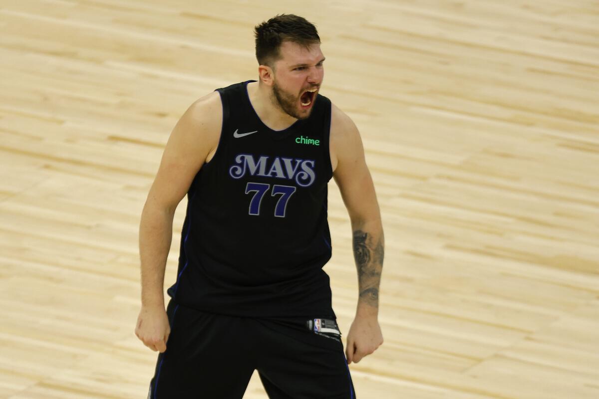Dallas Mavericks guard Luka Doncic celebrates after making a three-pointer against the Minnesota Timberwolves.