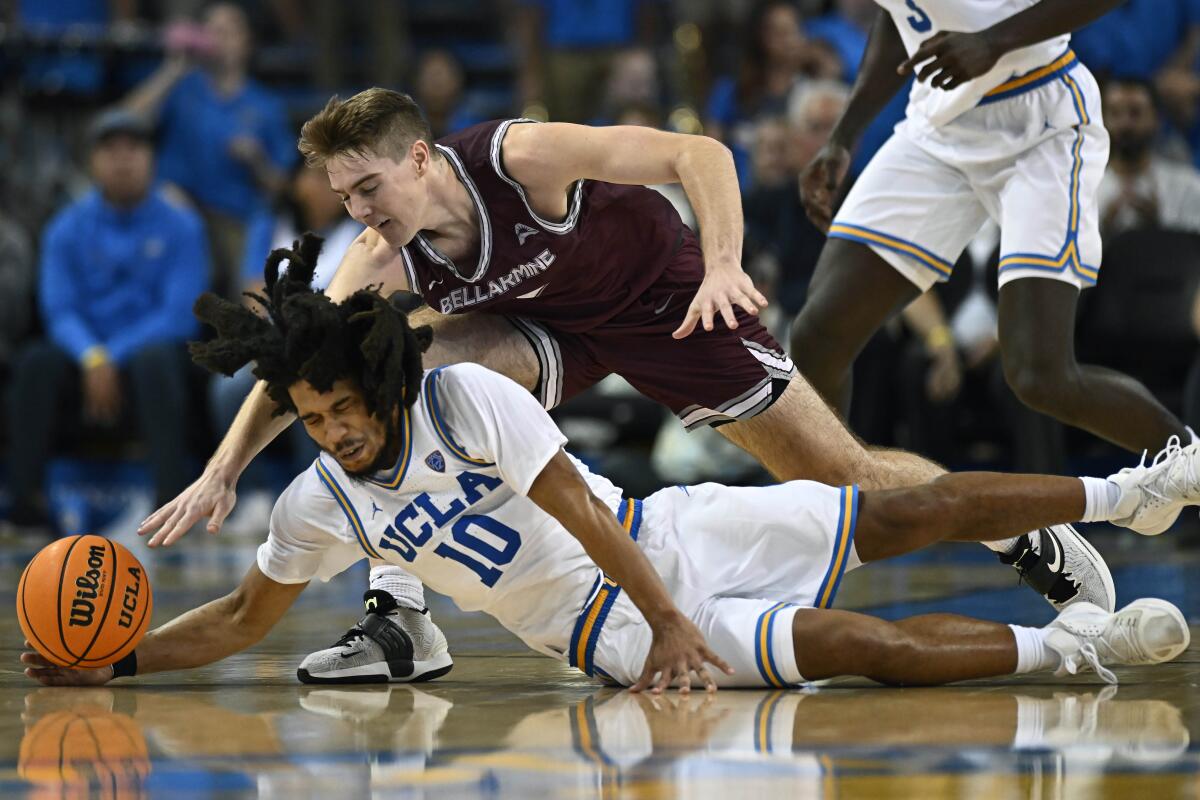 UCLA guard Tyger Campbell, below, takes to the floor in an attempt to steal the ball from Bellarmine guard Alec Pfriem