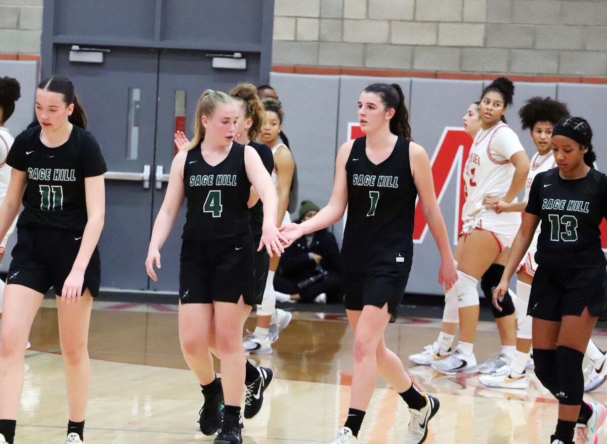 Sage Hill's Kat Righeimer (11), Grace Bori (4), Emily Eadie (1) and Zoie Lamkin (13) walk off the court during a timeout.