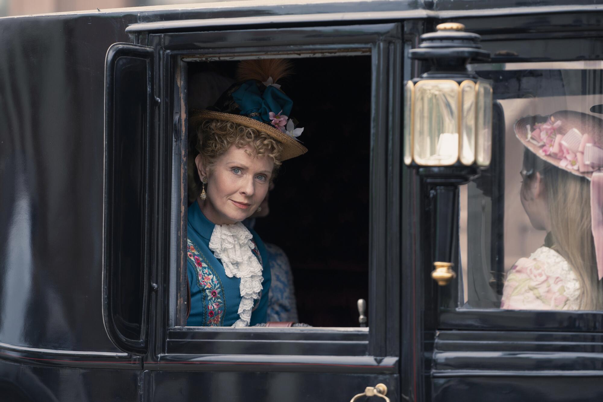 A woman in Gilded Age New York looks out the window of a carriage.