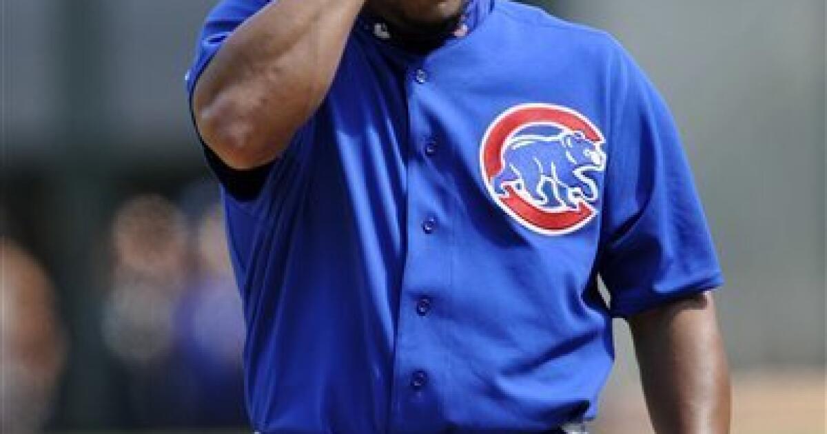 Chicago Cubs bench coach Alan Trammell, right, reacts as Derrek