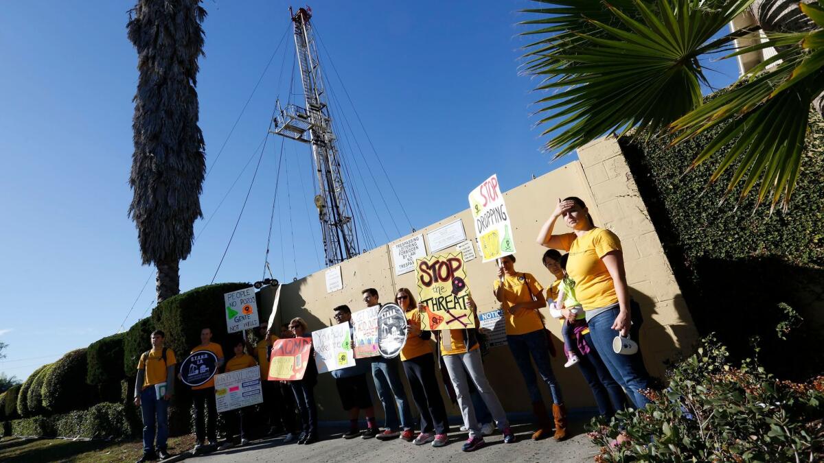 Community activists protest at a drilling site at Jefferson Boulevard and Budlong Avenue in 2015.