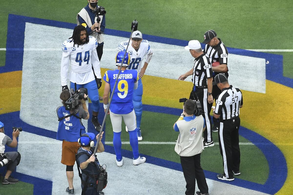 Rams quarterback Matthew Stafford (9) shakes hands with Lions quarterback Jared Goff in 2021.