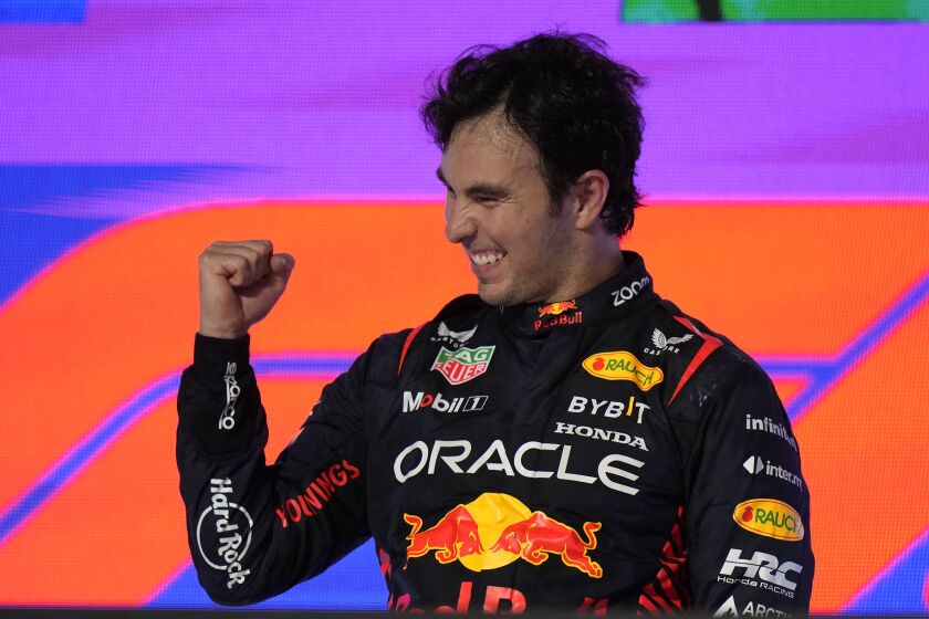 Red Bull driver Sergio Perez of Mexico celebrates after he won the Saudi Arabia Formula One Grand Prix at the Jeddah corniche circuit in Jeddah, Saudi Arabia, Sunday, March 19, 2023. (AP Photo/Luca Bruno, Pool)