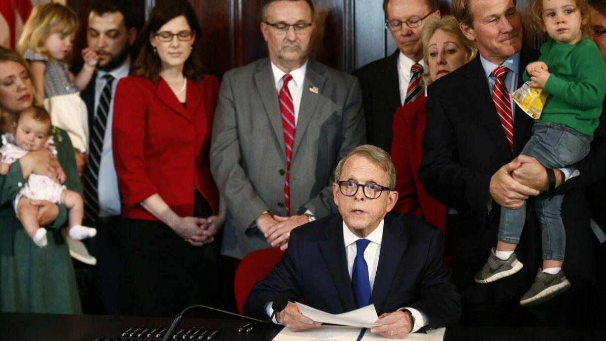 Gov. Mike DeWine speaks before signing a bill imposing one of the nation's toughest abortion restrictions on April 11 in Columbus, Ohio.