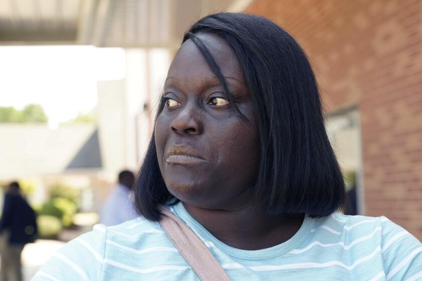 Deneka Samuel, of Jackson, Miss., cannot hide her disappointment and frustration at the problems with the city's water system, that she partially blames on racism shown by state and federal governments at the Black-majority city, Sept. 7, 2022, as she stands in the parking lot of Mount Nebo Baptist Church during a meeting of some African American community leaders with Environmental Protection Agency administrator Michael S. Regan, U.S. Rep. Bennie Thompson, D-Miss., and Mayor Chokwe Antar Lumumba. The meeting held in the church's small sanctuary kept a number of community leaders standing outside the room as they discussed the longstanding problems with the two water-treatment plants and its infrastructure. (AP Photo/Rogelio V. Solis)