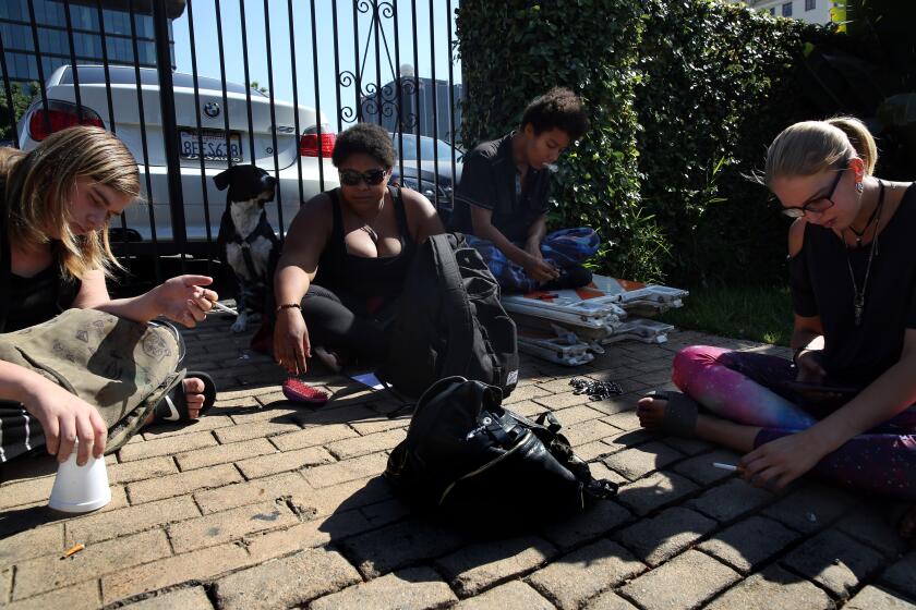 LOS ANGELES, CA-OCTOBER 29, 2019: Alisha, Keni, Gray, and Tea'annah, left to right, say they spend most of their time outside the shelter on Schrader Blvd. in Hollywood on October 29, 2019 in Los Angeles, California. They slept in a homeless encampment on Carlos and Tamarind Ave. for about a month. (Photo By Dania Maxwell / Los Angeles Times)