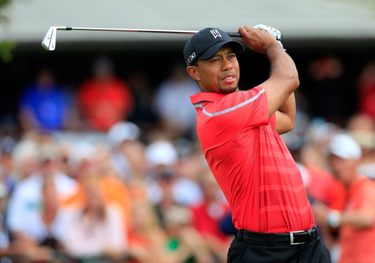 Tiger Woods hits his tee shot at No. 1 to open the final round of the Arnold Palmer Invitational at Bay Hill on Sunday.