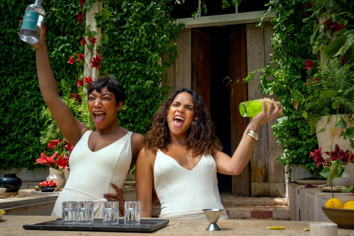 Two women celebrate on a tropical escape.