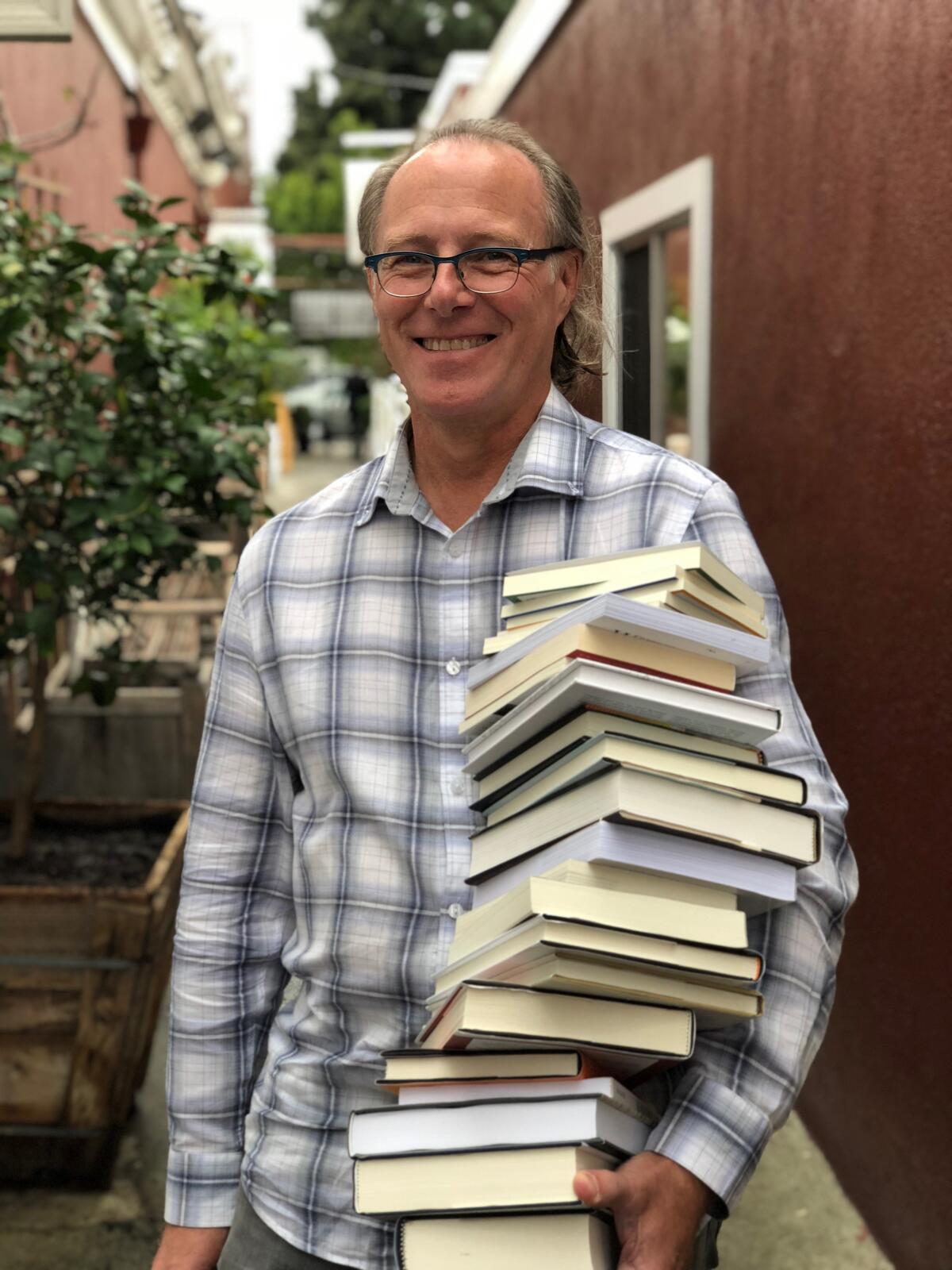 John Evans outside his Brentwood shop, DIESEL: A Bookstore.