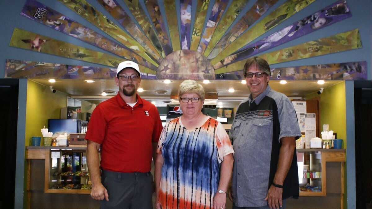 HERO board members Jake Pulis, left, Kay Ross and president Jeff Pingel at the Webster Theater, which the nonprofit is helping to draw more people.