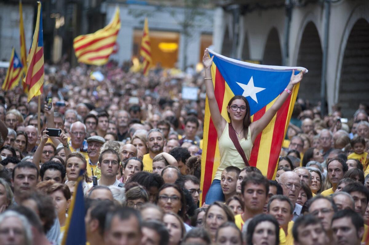 People demonstrate at town hall square against the Spanish Tribunal Constitutional prohibition of the November Catalonian independence referendum, in Gerona, Catalonia.